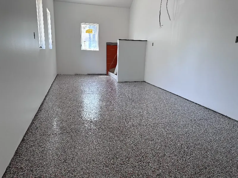 Variety of epoxy floor finishes in a garage, showcasing aesthetic versatility and customization options