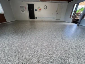 Surface preparation for epoxy flooring installation, highlighting tools and techniques used for optimal adhesion