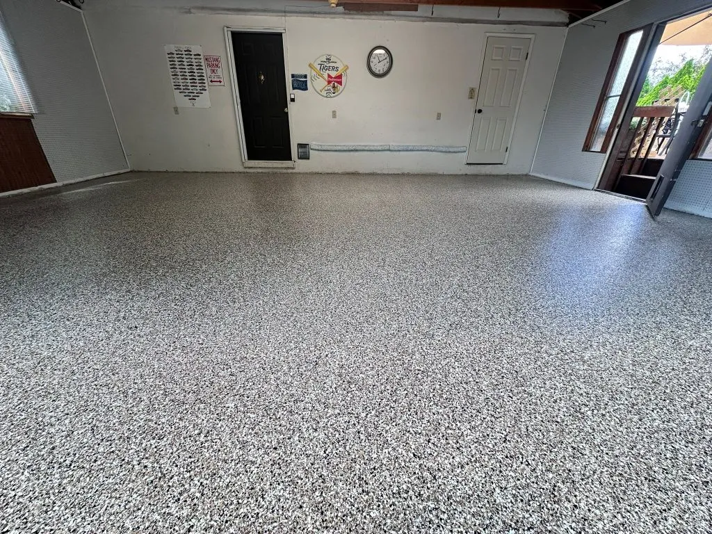 Person mopping an epoxy floor with a microfiber mop and pH-neutral cleaner