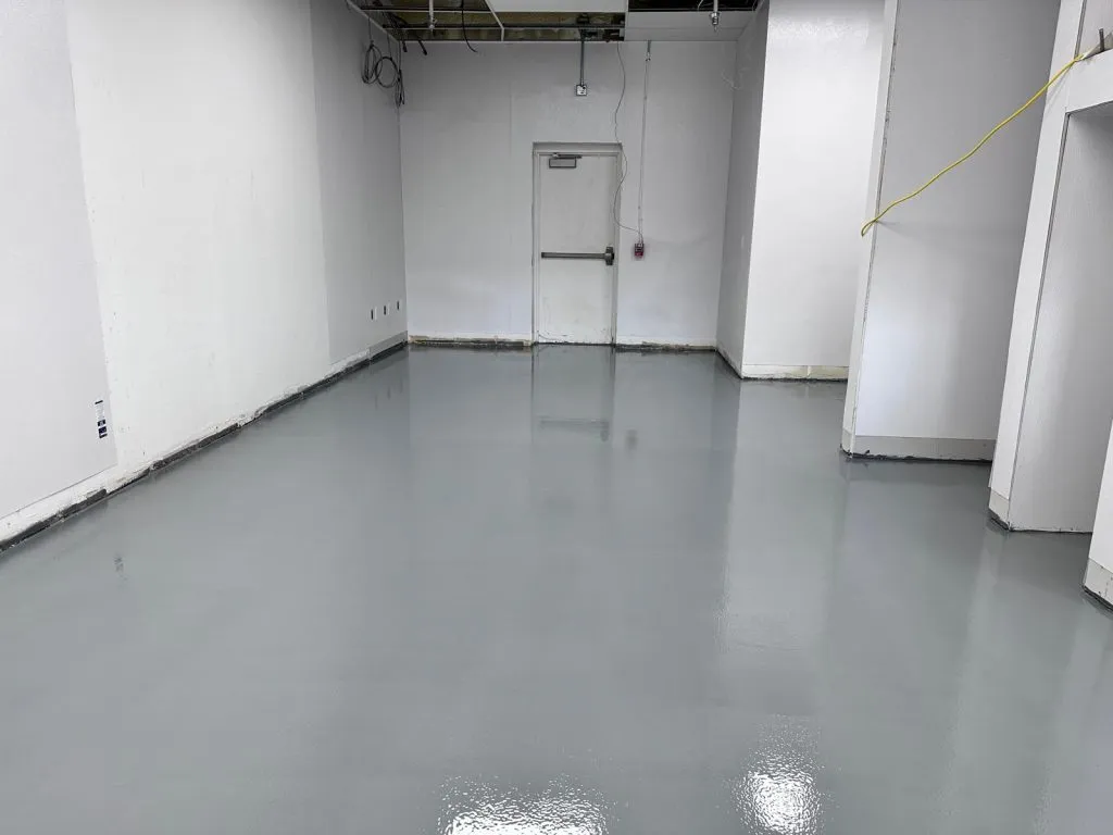 Close-up of epoxy filler being applied to a scratch on an epoxy floor